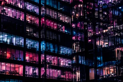 Illuminated Modern Glass Office Facade at Night
