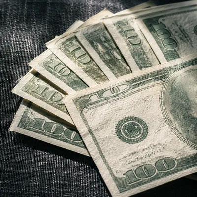 Fanned Dollar Bills on Charcoal Fabric