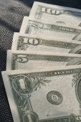 Close-Up Dollar Bills on Charcoal Fabric
