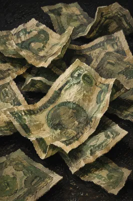 Moody Crumpled Cash on Dark Tabletop