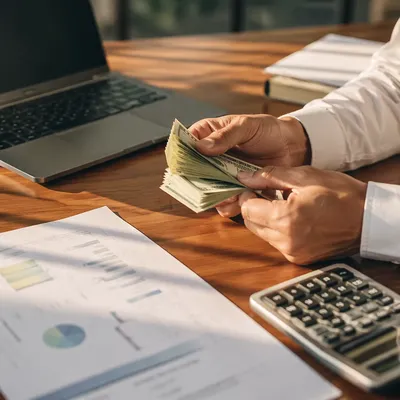 Counting Cash on Modern Office Desk