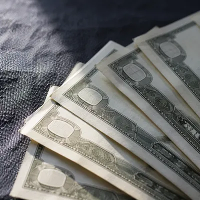 Close-Up Dollar Bills on Dark Fabric
