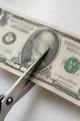 Scissors Cutting Dollar Bill Close Up