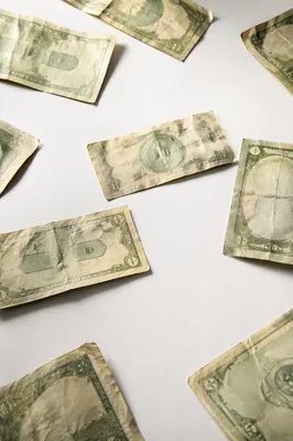 Scattered Green Currency on White Tabletop