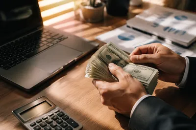 Counting Cash on Modern Business Desk