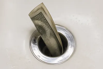 Money Draining Away in Chrome Sink