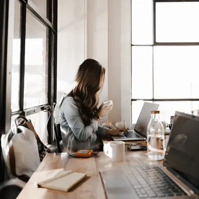 Modern Sunlit Office Workspace With Laptop