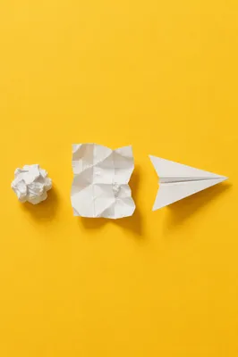 Paper Airplane Innovation on Yellow Desk