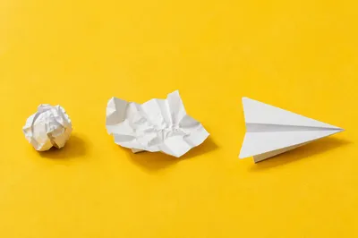Paper Airplane Creativity on Yellow Desk