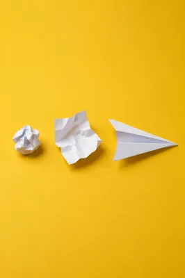 Paper Airplane Innovation on Yellow Desk