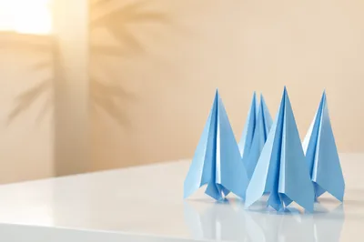 Blue Paper Airplanes on Modern Office Desk