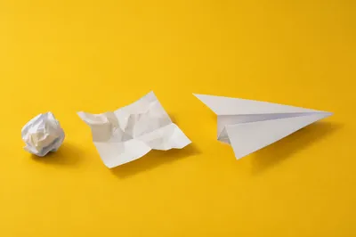 Paper Airplane Innovation on Yellow Desk