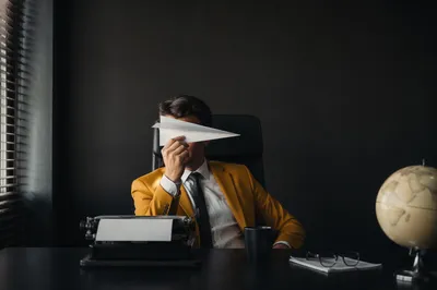 Paper Airplane Innovation on Executive Desk