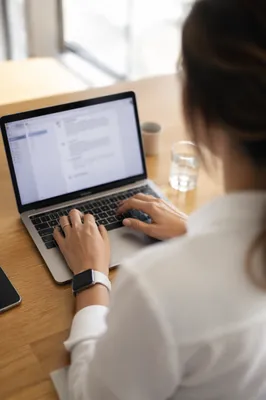 Professional Writing Email on Laptop Desk