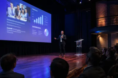Presenter With Projection in Dark Auditorium
