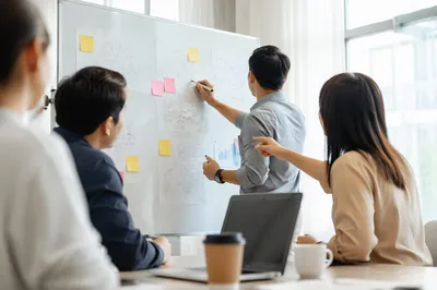 Team Brainstorm at Conference Room Whiteboard