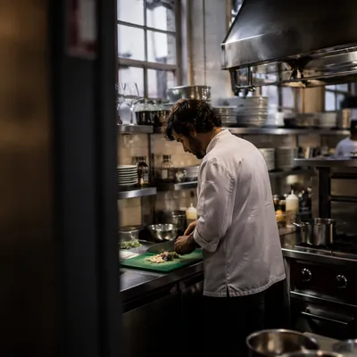 Chef Preparing Vegetables in Restaurant Kitchen