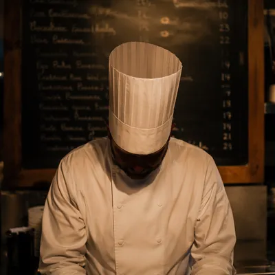 Focused Chef in Warm Restaurant Kitchen