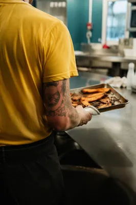 Chef Preparing Roasted Food in Busy Kitchen