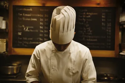 Focused Chef in Warm Restaurant Kitchen