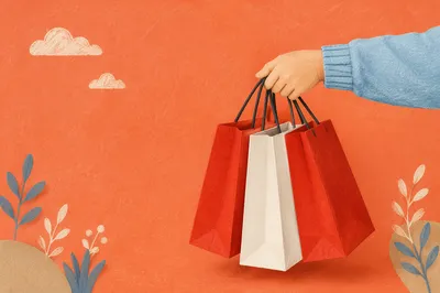 Hand Holding Shopping Bags on Orange Background