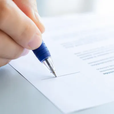 Hand Signing Contract with Blue Pen