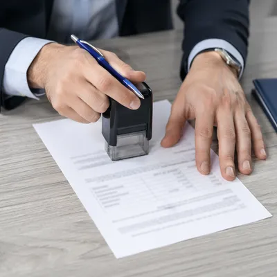 Business Contract Signing With Stamp and Pen