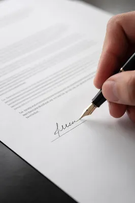 Hand Signing Business Contract with Fountain Pen