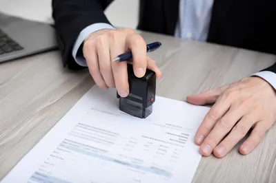 Business Contract Signing With Stamp and Pen