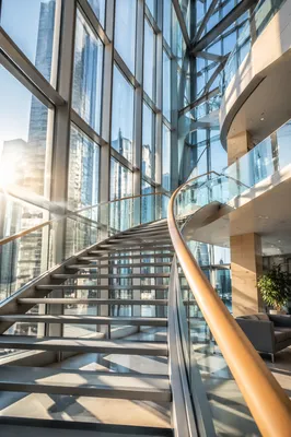 Ascending Staircase in Modern Glass Office Atrium