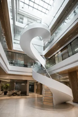 Ascending Spiral Staircase in Modern Office Atrium
