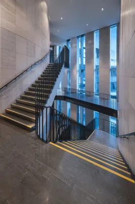 Ascending Staircase in Modern Office Atrium