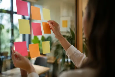 Colorful Sticky Notes on Glass Wall