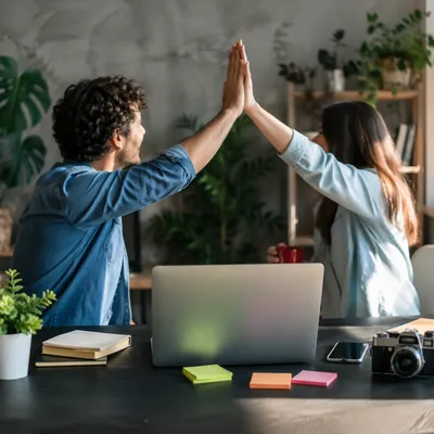 Coworkers Celebrating Project Success With High Five