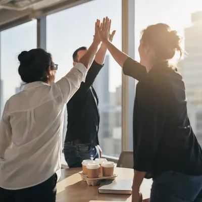 Coworkers Celebrating Success with Office High Five