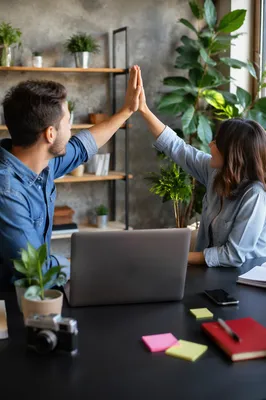 Coworkers Celebrating Project Success With High Five
