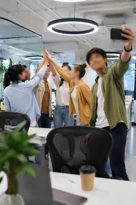 Coworkers Celebrating Project Success in Office