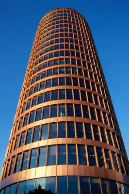 Modern Copper Office Tower Against Blue Sky