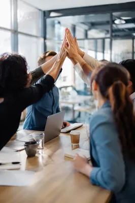 Office Team Celebrating Success With High Five