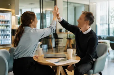 Coworkers Celebrating Project Success With High Five
