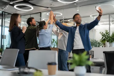 Coworkers Celebrating Project Success With High Fives