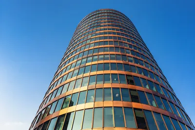 Modern Copper Office Tower Against Blue Sky