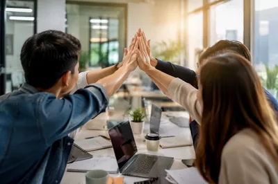 Office Team Celebrating Success with High Five