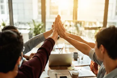 Team High Five Celebration in Modern Office