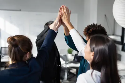 Office Team Celebrating Success with High Five