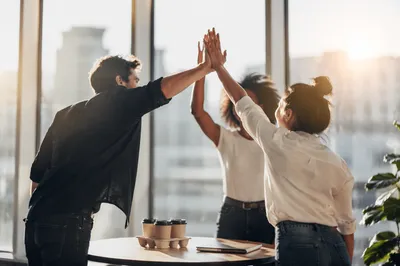 Team High Five Celebration in Modern Office