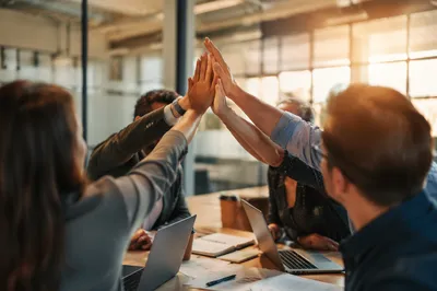 Team High Five in Modern Office
