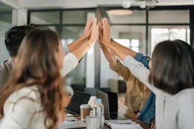 Office Team Celebrating Success With High Five