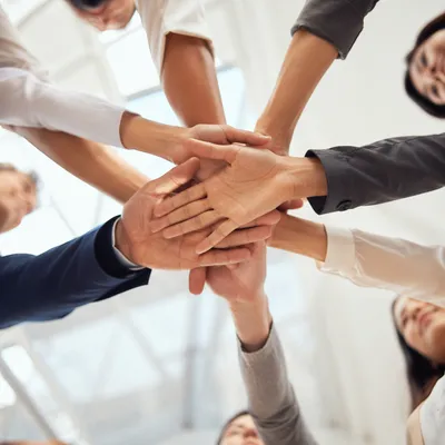 Unified Business Team Hands in Office Atrium