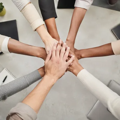 Diverse Team Hands Stacked in Unity